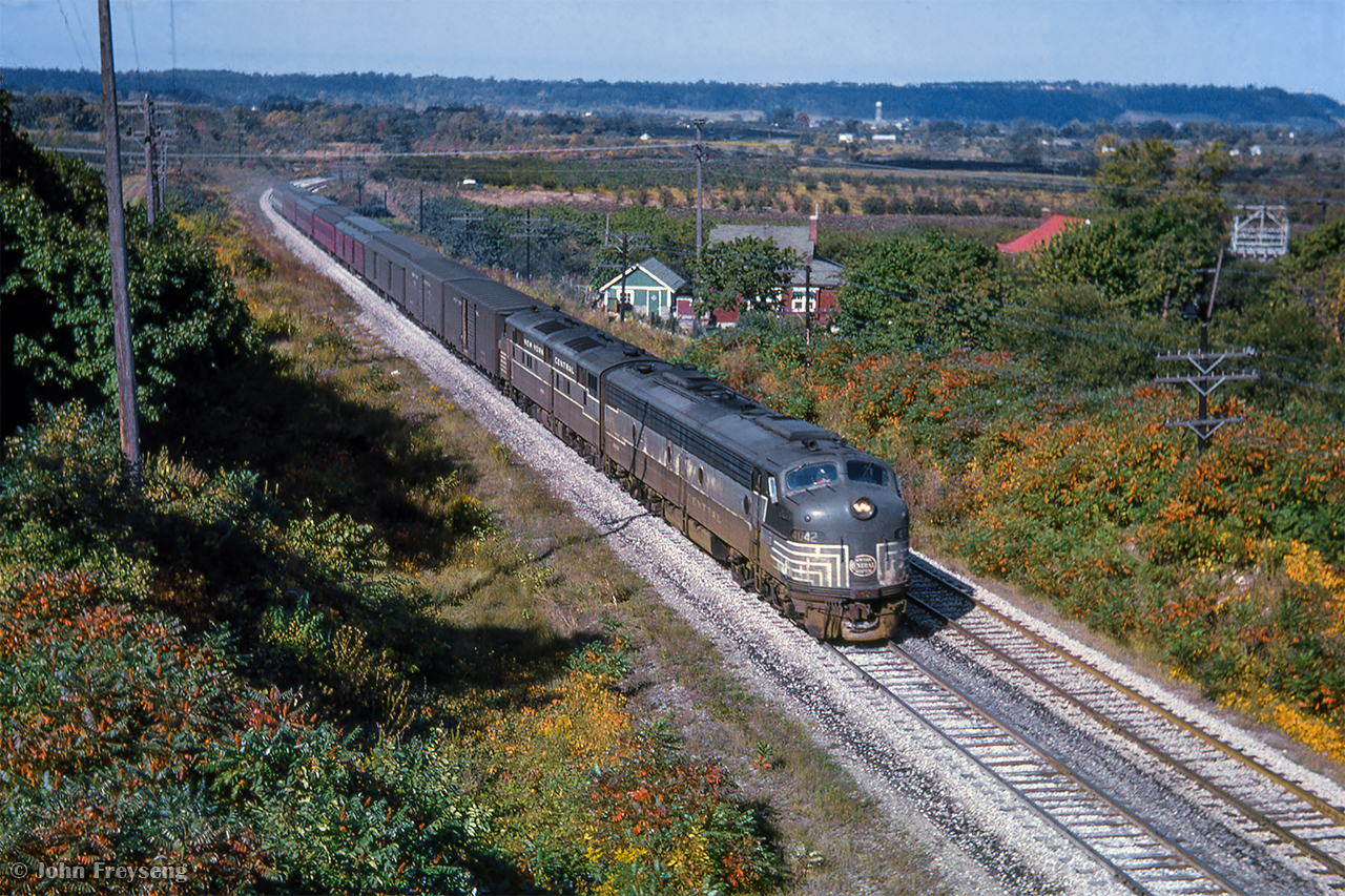 After shooting it at Bayview as CPR 321, the Toronto - New York train has changed power and numbers at TH&B Hunter Street, seen climbing the Niagara Escarpment at Highway 20 in Stoney Creek as TH&B 372.

Scan and editing by Jacob Patterson.