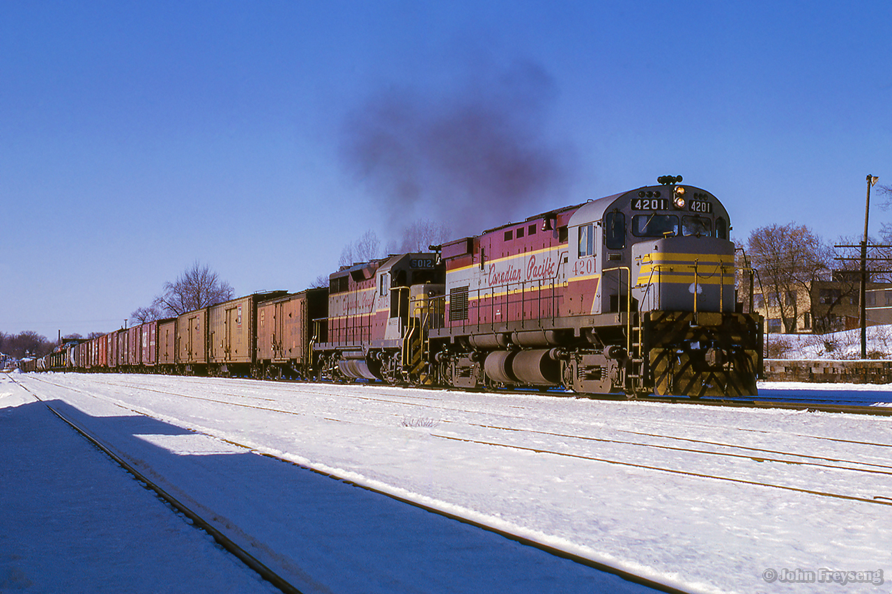 An eastbound freight for Montreal passes through Belleville behind a C-424 (still with its high-mounted headlight,) and a GP35.

Scan and editing by Jacob Patterson.