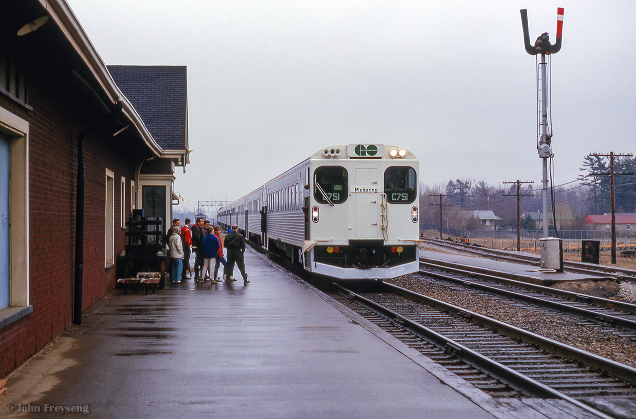 The first GO test train to be operated over the Oakville Sub is seen eastbound at CN's Port Credit station with cab car C751 in the lead.  GMD GP40TC 602 shoves on the west end of the train.

With GO service preparing to begin on May 23, 1967, testing was getting underway starting with two runs on this day from Spadina - Oakville - Pickering and return.  The same trip would operate again on April 10 for project officials.  Beginning April 11, and accompanied by CN dynamometer car 69, GO equipment would head for Fort Erie to begin testing along the Cayuga Sub between Welland Jct. and Canfield Jct. to evaluate acceleration and braking.  Mimico - Niagara Falls testing would take place during early May, with final test runs taking place Oakville - Pickering in the final days leading up to the start of service.

Prior to all this, GO 600 had been sent north to Fort William, where coaches were under construction by Hawker-Siddeley.  This equipment was operated in testing over CN's Kinghorn Sub from Fort William to Longlac.  Further information found in UCRS newsletters from March, April, and June, 1967.

Scan and editing by Jacob Patterson.