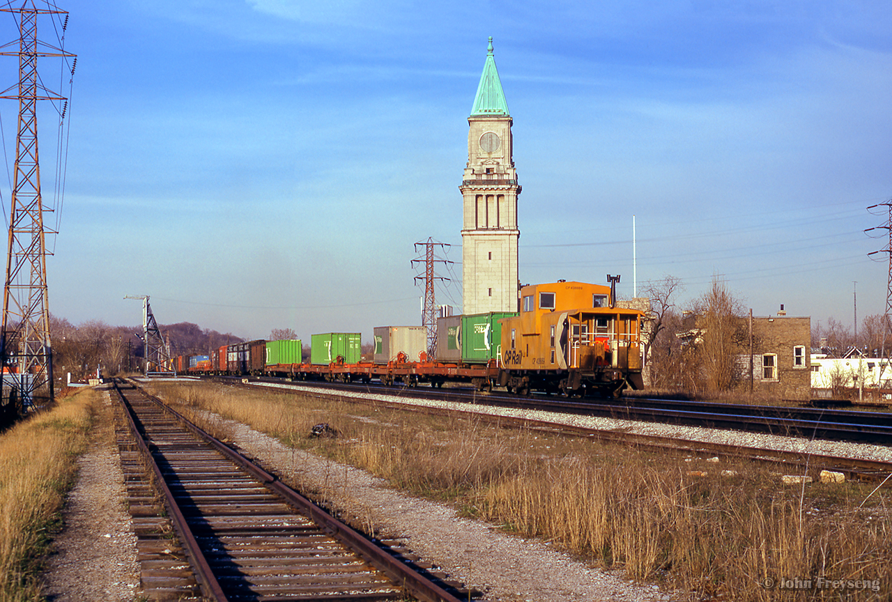 A spring evening finds an eastbound along the North Toronto Sub, passing the old north Toronto station at Yonge Street with Angus van 438889 carrying the markers.

Three C424s on the head end

Approaching the scene.

Scan and editing by Jacob Patterson.