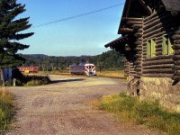 Ottawa - Montreal train 132 approaches the 1931-built log station at Montebello.  Serving its last train in 1981, the station was relocated to main street in 1989 where it now serves as a tourist information centre.


<br><br><i>Scan and editing by Jacob Patterson.</i>