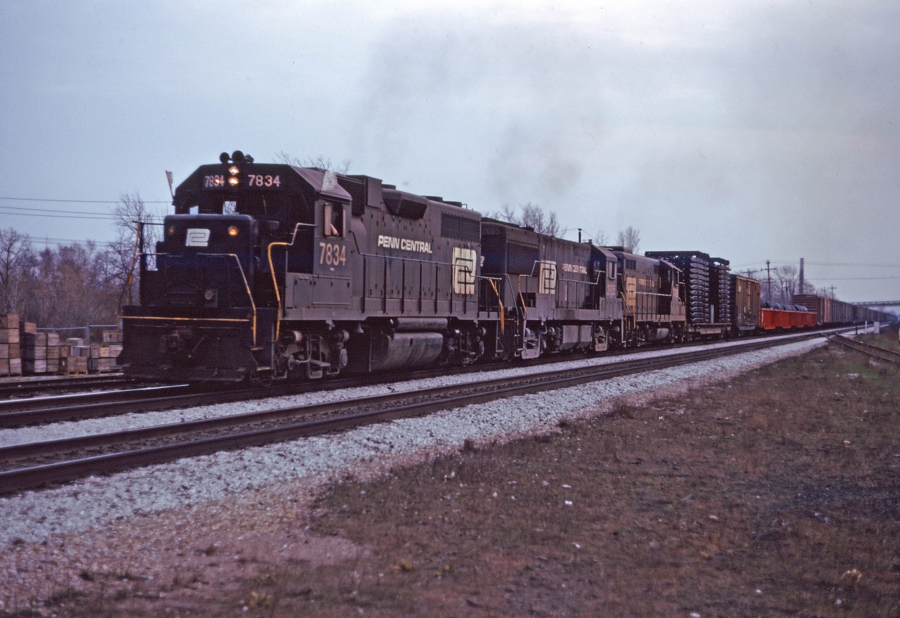 By the mid-1970s, the London built GP9s and GP7s which had held down the CP-TH&B-NYC/PC run-through trains for years were showing their age and often supplemented by Penn Central second generation 4-axle units. Today the Starlight has GP38 7834, U25B 2605, and GP9 7429 leading the train up the grade into Aldershot on their way back to CP's Toronto Yard ("Agincourt"). Hard to believe it's been over 50 years since this shot was taken...