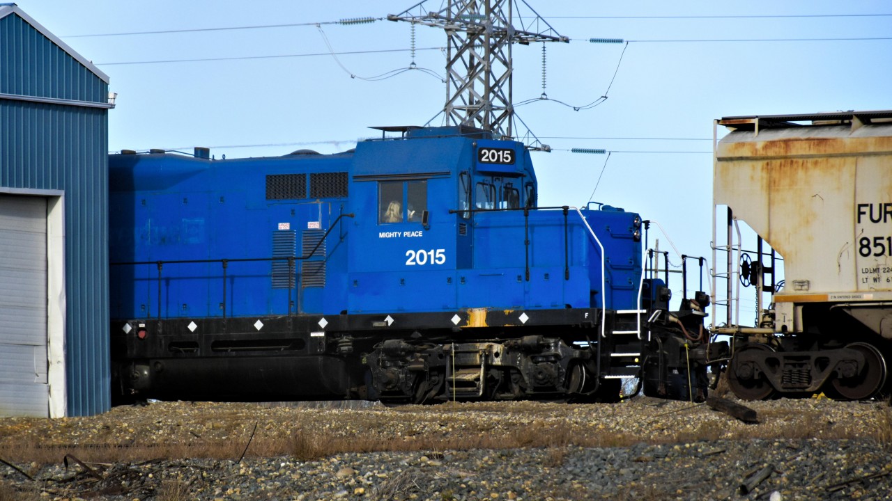Previously owned by Louis Dreyfus, this locomotive is used for switching grain cars around in the small Dawson Creek yard. Mighty Peace is now written on the side. Also, the building to the left is the shed in which the locomotive is kept.