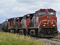Three old Dash 9s (the middle one being a rare C44-9WL) lead a single LPG car out of the loading facility towards the grain elevators behind the camera. Ironically, the locomotives outnumber the cars 3-1, equaling a total of 22 axels... 