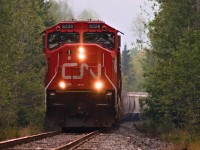 CN 8328 leads a heavy sand train north to Fort St. John. This was the longest train I have ever seen, at 830 axels, and also two mid remotes! The train was broken up into two parts, one half was sand, and the other half being LPG. Note the heavy smoke in the air. 