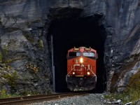 CN 2969 grinding up the steep grade to the summit of the Pine Pass towards Prince George with A47521 in tow. This train is just emerging out of the only tunnel on this line, which goes underneath the highway 97. In a few miles, this train will pass Azouzetta Lake. 