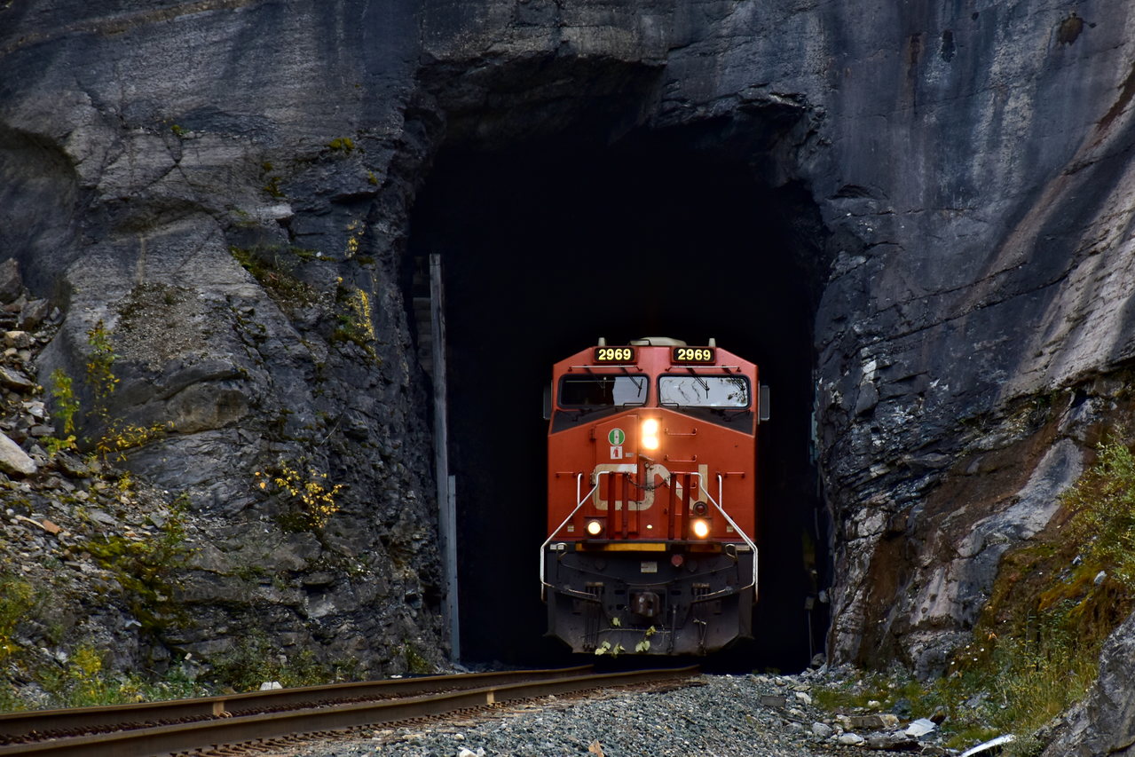 CN 2969 grinding up the steep grade to the summit of the Pine Pass towards Prince George with A47521 in tow. This train is just emerging out of the only tunnel on this line, which goes underneath the highway 97. In a few miles, this train will pass Azouzetta Lake.