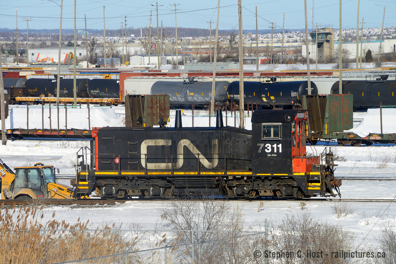 Heritage units? While everyone freaks out about CN's America 250 heritage units the real heritage is at mac yard, toiling away, and you have to be lucky to find it working let alone this far south. CN 7311 is the last CN SW1200 officially on the CN active roster, but there are others: RT110/1394 in yellow at Mac Yard, 7304 in Hamilton, and fairly recently in 2020 one or two at the Hallet Dock company in Duluth  as CN bought this dock and assigned DMIR 1250 (ex CP) and 1251 to the dock. 1250 to replace a green NW-2 that's been a fixture at that dock for many decades.