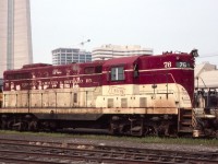 TH&B GP-7 #76 is seen near Toronto Union Station in August of 1985. Seen in the background are the base of the CN tower and part of Toronto's growing skyline. Note the Chessie unit hiding in back.