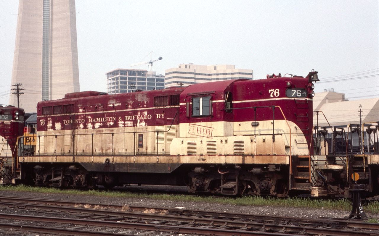 TH&B GP-7 #76 is seen near Toronto Union Station in August of 1985. Seen in the background are the base of the CN tower and part of Toronto's growing skyline. Note the Chessie unit hiding in back.