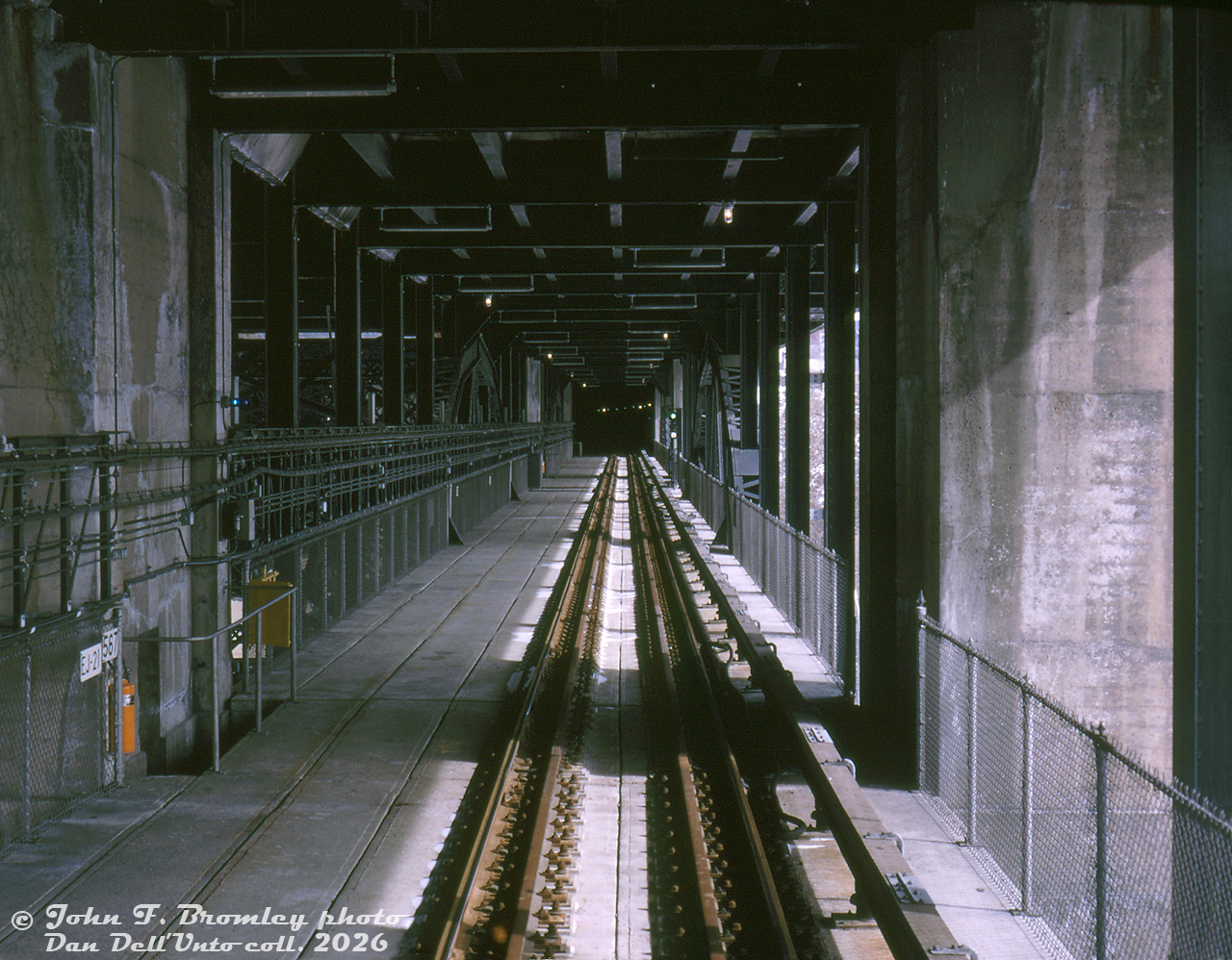 A few days before the official opening of the new Bloor-Danforth subway line for revenue service on February 26th 1966, a special fantrip run was made on the 19th with a short H1 consist over the new subway line, which also included a stopover and visit to the new Greenwood Yard and shops. Here, the train is seen crossing or paused on the Bloor Viaduct (or, Prince Edward Viaduct), showing the new subway track right-of-way running underneath the roadway above.

When it was originally built during the 1910's, the viaduct above the Don Valley only carried automobile and streetcar traffic above, but was built with a lower level with the intent that someday it might be needed for a rapid transit line. Nearly 50 years later in the 1960's, it was made use of by the new crosstown subway line to span the Don Valley between Sherbourne and Broadview stations. A good example of transit infrastructure planning for the future!

John F. Bromley photo, Dan Dell'Unto collection slide.