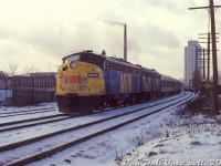 On a cold January 1979 day in east end Toronto, VIA FP9 6524 and an ex-CN 6800-series FPB4 head an eastbound passenger train on CN's Kingston Sub at Mile 331, around Gerrard Street East underpass. This was likely shot at or near the old Pape Avenue grade crossing, not too long before it was eliminated for a pedestrian bridge. The tower in the background is the Ray McCleary Towers at 444 Logan Avenue.
<br><br>
<i>Original photographer unknown, Dan Dell'Unto collection slide.</i>