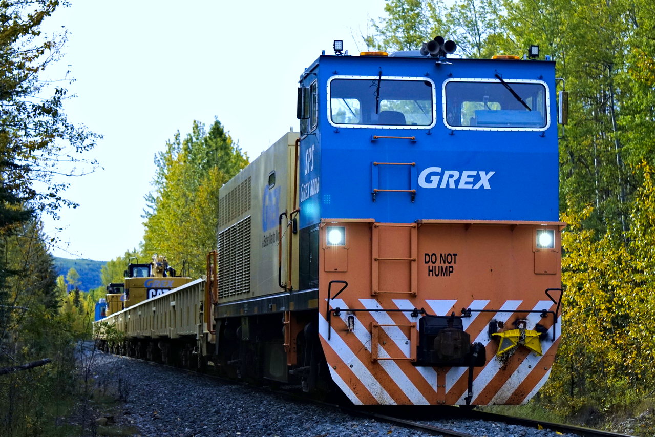 A GREX work train glides into the curves on the CN FSJ subdivision. The train was actually going backwards, presumably heading back to Chetwynd after a day of work. Note the two excavators on top of the well cars used for picking up ties, as well as the 'Do Not Hump' lettering on the locomotive.