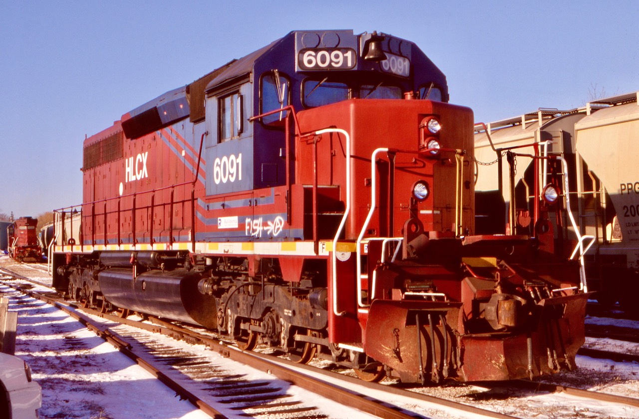 The early years of six axle power on the GEXR was interesting with a trio of leased HLCX SD40’s coming from sister GW company CORP. The trio reportedly came equipped with Woodward traction control equipment that was a bit complicated to maintain. Nevertheless the trio lasted several years before being replaced by other SD40’s and of course the popular “tunnel motor”. HLCX 6091 was a personal favourite for me as it was a former CN SD40. A former Conrail SD40 and Rio Grande SD45 rebuilt into a SD40 rounded out the group. This day 2 of the lessors were in Goderich with the third in Stratford.  The 6091 still sports CN’s dual air tanks and notched cab roof above the bell where the horn was once located. I’m not sure where these units ended up after their time on the GEXR but one story had them sold for scrap.