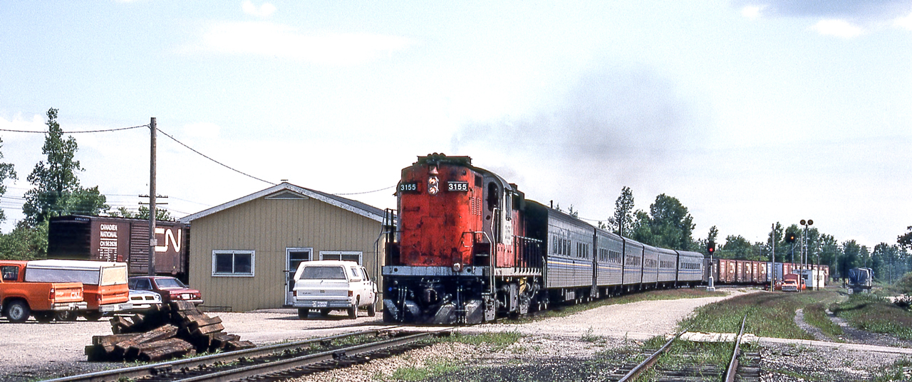 CN 3155 is westbound in Komoka, Ontario on August 13, 1982.