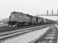 <br>
<br>
 Nineteen Seventies power,
<br>
<br>
open bi-level auto carriers....
<br>
<br>
GMD 1974 built GP40-2L(W) CN 9408 and  GMD built sisters,
<br>
<br>
Eastbound on a grimy gray January afternoon,
<br>
<br>
At a snowless Paris Junction, January 19, 1980 Kodak Tri-X negative by S.Danko 
<br>
<br>
