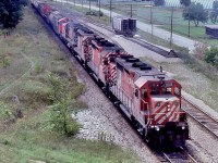 <br>
<br>
GMD GP-35's rule...well almost...
<br>
<br>
Eastbound CP Rail 5008 – 5019 – 5011 – 4221 with a SW 81xx, with the Hogger having a close look,
<br>
<br>
slows for a  westbound – in the hole -  CP Rail 5798 – 5799 assisted by C&O 3004 
<br>
<br>
 <a href="http://www.railpictures.ca/?attachment_id=  58044">  5798 West  </a>
<br>
<br>
At Coakley, September 9, 1979 Kodachrome by S.Danko
<br>
<br>
