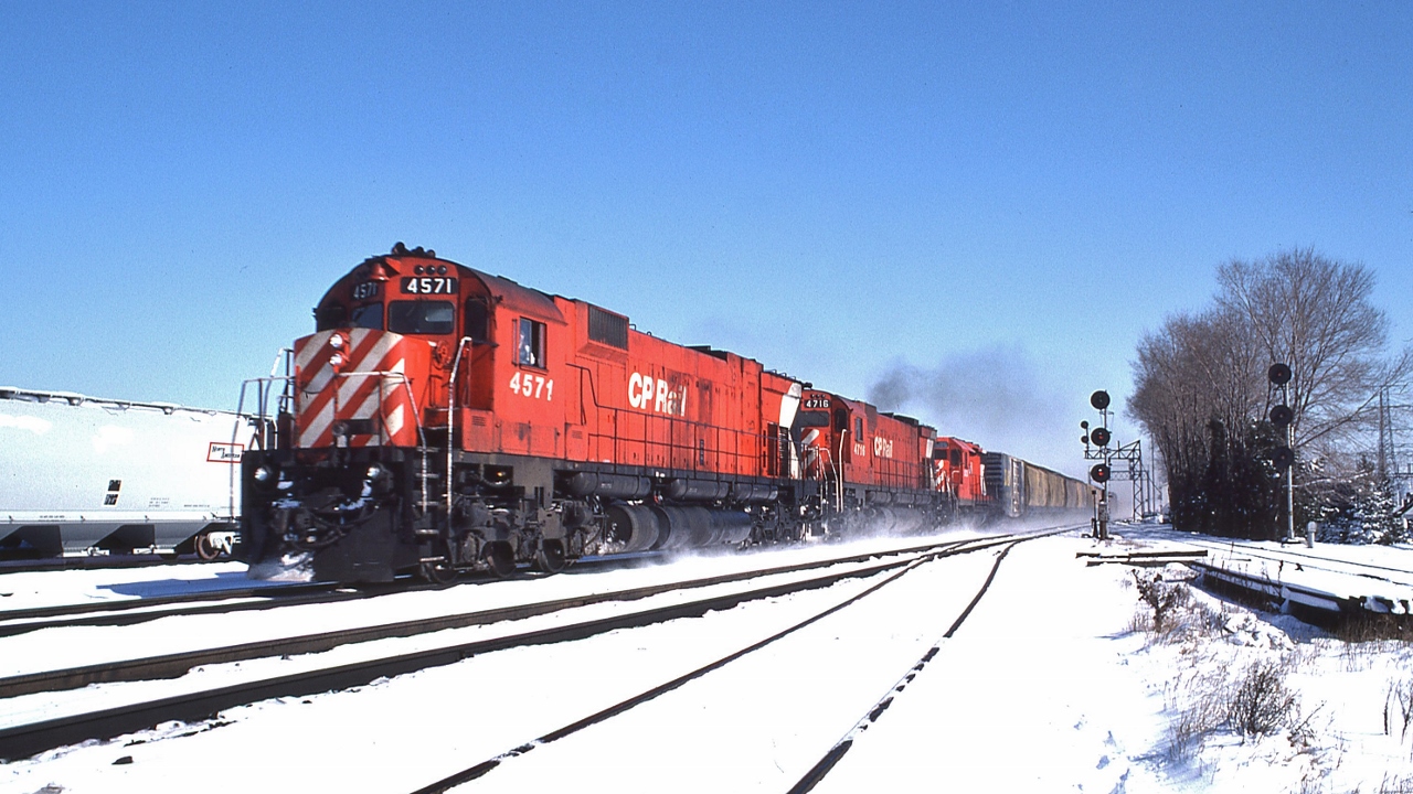 A pair of MLW's finest enter the North Toronto Sub., no flags, this westbound is a regularly scheduled movement


CP Rail 4571, MLW 1969 built M-630


CP Rail 4716, MLW 1970 built M-636


The trailing GMD appears to be a 5000 series GP-35


And on the South Track that's a high green for an eastbound, at Leaside, March 2, 1980 Kodachrome, with a Nikkor 28mm f2.8 lens, by S.Danko


noteworthy


The original Leaside Junction consisted of one crossover to accommodate westbound north track access to the Don Branch


At extreme right is  top end of The Don Branch, Belleville Sub mile 206.3 (the route to the Don station site mile 209.5) 


 Some of the final CP trains to use the Don Branch were the 2816 excursion train dead head movement with Go Transit equipment and the  2004  CP Holiday train. 


The Don Branch is currently owned by Metrolinx and in a state of disrepair and partially removed. Apparently Metrolinx had an idea to speed up the Richmond Hill GO trains by using the CP Don Branch (3.2 miles) – CP Belleville Sub through Leaside (1.3 miles) – CN Leaside (ex CNoR) Branch (2.2 miles) route to CN Oriole on the Bala Sub as a replacement route for the slow 30 m.p.h., curvy Don Valley Bala Sub (miles 2.0 at CN Don to Mile 11.3 CN Oriole)  – except CP had quite the price to allow so. So you and I own – purchased by Metrolinx from CP for a price we'll never know - a piece of derelict railway right-of-way that will likely never see a GO train.


At extreme left the six track Leaside yard  - that stretched from near Wickstead to Bayview Ave - is gone, removed over the past ten years or so.


More


   Leaside  - west end  


sdfourty