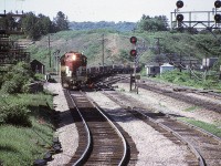 Here's a shot from 50 years ago at a location I seldom frequented. I am trackside at almost below Hamilton's High Level Bridge. Wandering along, I was caught off guard by what I considered at the time an early edition of  that daily Toronto to Hamilton and return Starlite. TH&B 72 is leading in this scene in which the train is on the CN to CP connector which enables it to access Aberdeen Yard in Hamilton's west end.
Note the track side shanties. There used to be so many of these. Small ones held tools and wayside equipment whereas in larger ones the maintenance guys could store their putt-putts (speeders). All now relics of the past.