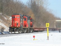 CN GP9s 7076 and 41xx power a movement of steel flat cars upgrade at Copetown, ON on February 16, 2008. Not sure what this train ID was.