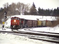 Just another winter's day hanging out at "The Junction."  Sitting somewhere warm, like in the car, a green goes up for an eastbound 'off the hill' so I scurry over to the south side in anticipation. A freight shows, seen about to enter the Oakville sub at the Junction with a trio of GP40-2L units, 9634, 9597 and 9565. I count off 60 cars and record the van as #79768. Mildly disappointed the power wasn't a little more of the unusual variety, but hey, there is always another train.