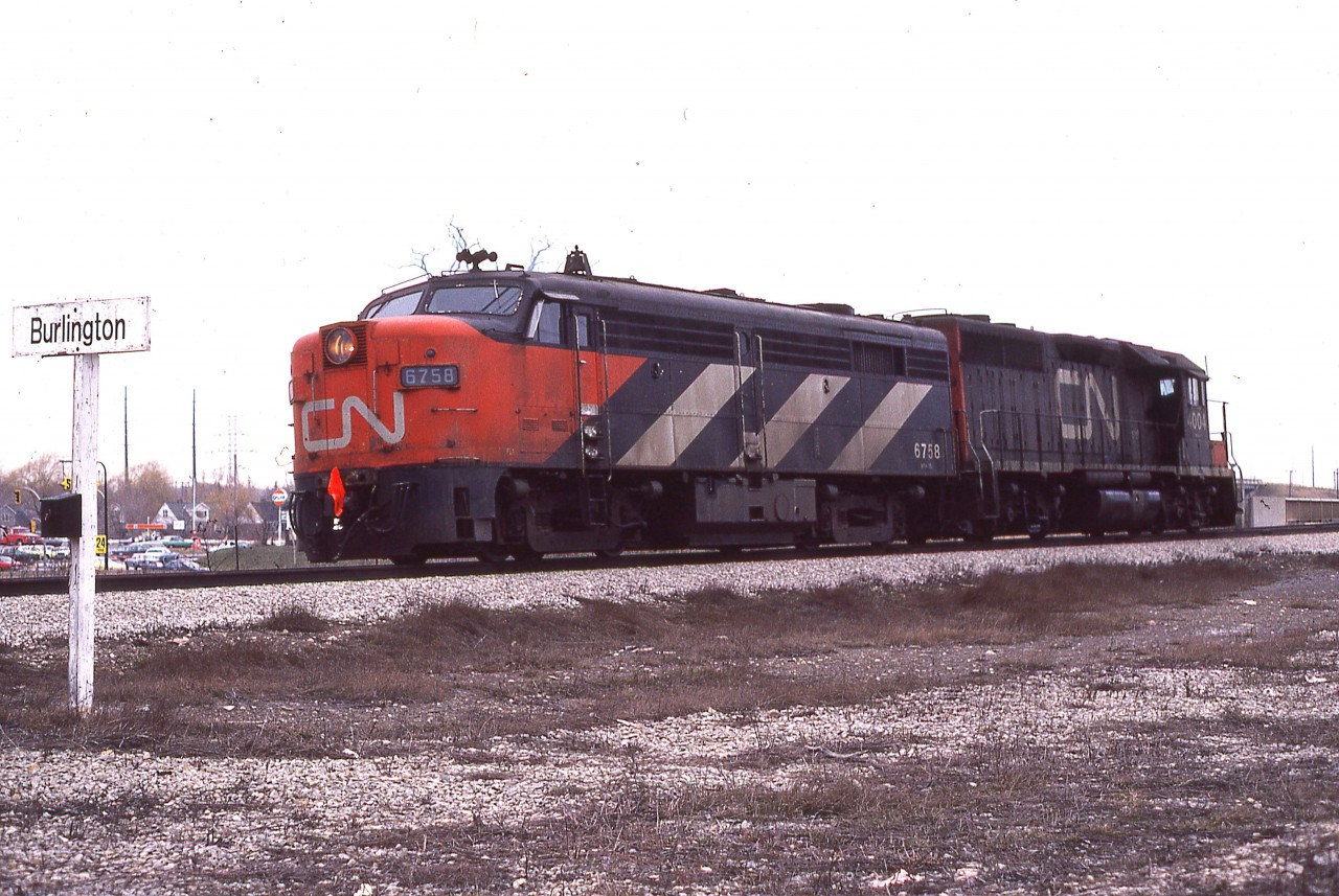 I never did find out what ailment affected the 'rare' MLW FPA-2u #6758; but it languished away at Hamilton's Stuart St engine house for awhile before finally being towed off to (I presume) MAC yard by CN 4004 on a special move.  It is a dreary Sunday morning, rather fitting for the occasion.
Note this is pre- Burlington WEST.
