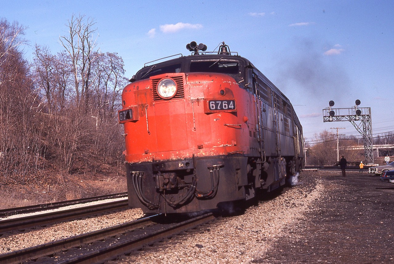 Close-up of a westbound VIA train showing CN 6764 after a "Nose Job".
Many, or most, of these old cab units either had their nose "CN" covered up and then painted into VIA colours later, or just went straight to the VIA paint job.
I've never been able to compile a list of who got what over the years.