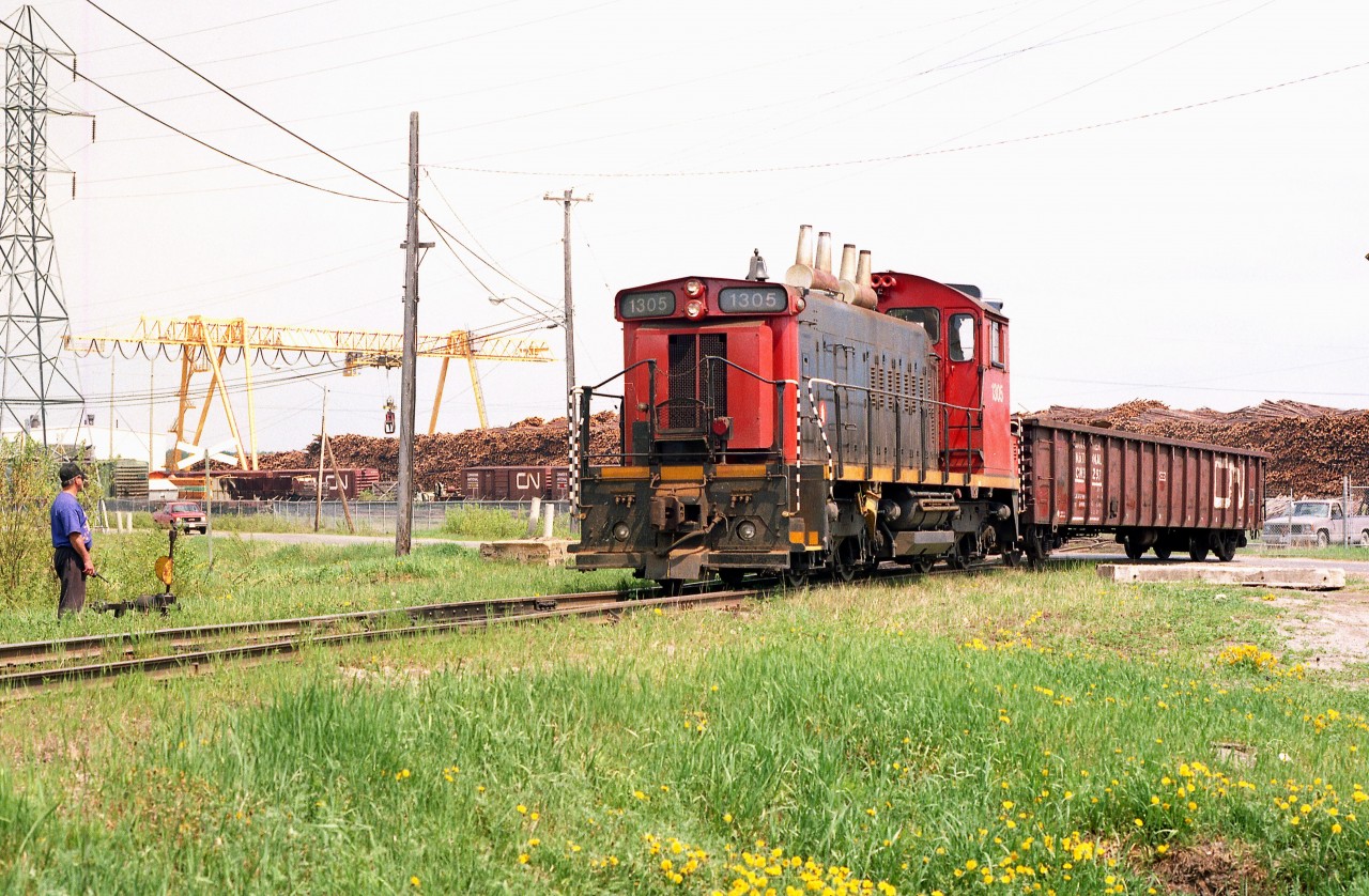 It was interesting news this January past when the switcher that worked the pulp and paper company in Iroquois Falls for so many years under Abitibi and eventually Resolute Forest Products, has now returned after a stint in Thorold South, last with Bioveld. Abitibi bought the unit from CN in 1993. Iroquois Falls mill closed in 2014 and the unit was relocated to Thorold.  Now, under great fanfare, it has returned to "The Falls" as the resident switcher for the new Abitibi Connex logistics hub, which has taken over the old pulp and paper lands.
The 14 mile line from Porquis Jct to Iroquois Falls has been upgraded and now in service.
The image I have posted shows the unit back in its earlier days as it comes up to a switch. Note the mass of logs in the background. The loss of the forest products business devastated the community and it is nice to see that life has returned by way of this new logistics company
I understand the 1305 sports a brand new attractive paint scheme, making a side trip while in the north this spring a worthwhile adventure.