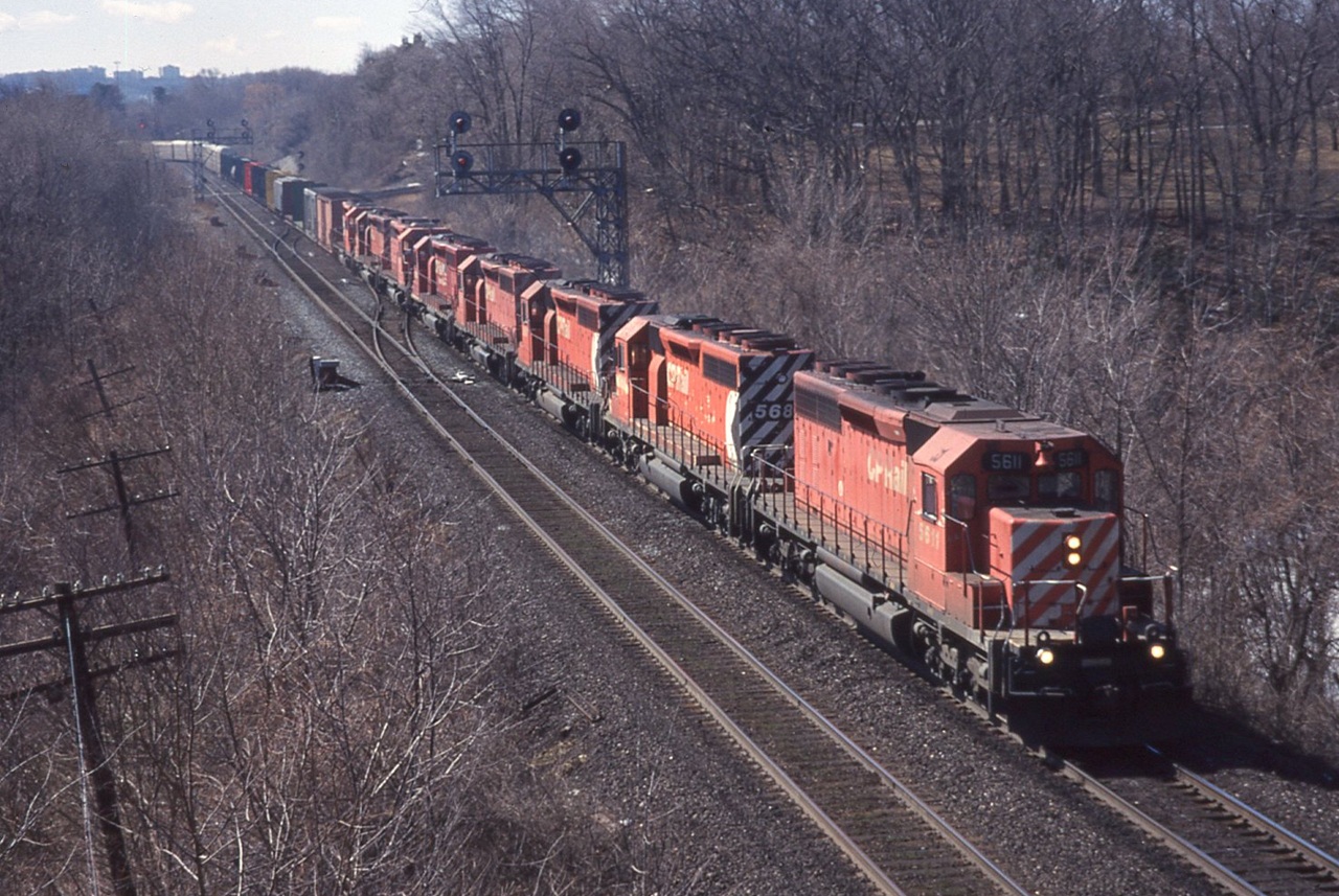 On March break back in 1999 we caught CP 521 rolling through CN Bayview Jct. on the way to Toronto. Brother Greg must have been there because all the locomotive numbers were recorded, and I'm impressed that I managed to squeeze them all onto the slide mount. From front to back we have CP 5611, 5689, 5697, 5682, 5596, 5506, 5670 and 5608. It looks like they're all in CP action red with the exception of 5596 that is in CP Rail System paint.
