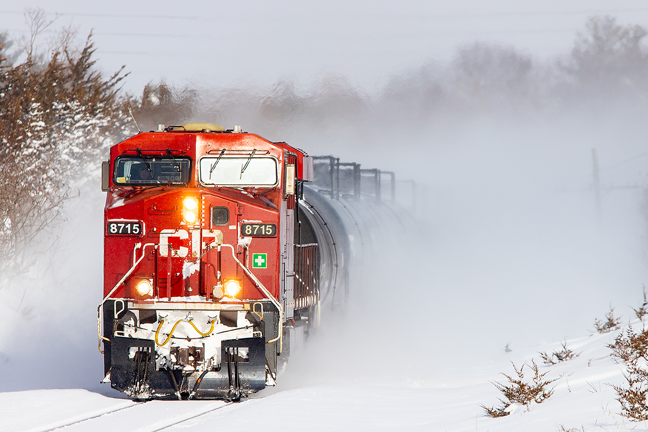 CP 8715 kicks up almost 40cm of fresh snow as it blasts through Trenton on it's trip west.