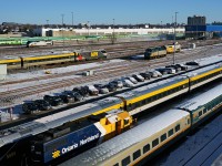It's a cold morning in Toronto as VIA 97 zips past an assortment of parked equipment at VIA's Toronto Maintenance Centre and GO Transit's Willowbrook Yard. 