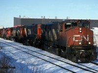 A daylight CN 422 is captured at the east end of the siding in Kitchener, Ontario with a trio of M-420(W)’s that included; 3517, 3551 and 3527 with GP9RM’s 7039 and 7040. Both GP9RM’s were being lifted for MacMillan Yard in Toronto (Vaughan) after being assigned to Kitchener.