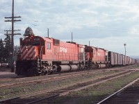 A westbound CP freight lead by a pair of MLW M-636s, 4738 and 4711, roll past the old Canadian National station in Thunder Bay Ontario on July 27. 1977.