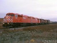 Brand new CP Rail SD40-2F units 9000 and 9001 lead SD40 5410 and SD40-2 5945 on eastbound train #904. It has just departing CP's Toronto (Agincourt) Yard, and is heading down the connecting track from the northeast end of the yard (Tapscott) to enter the Belleville Sub (Staines), about to cross Neilson Road (this connecting track didn't historically appear to have an official name, but shows as the "Staines Cross Connection" in more recent timetables).
<br><br>
The new cowl-bodied SD40-2F's, CP's last new SD40-2 model (built with 645 engines at CP's insistence, well after EMD moved on to the 710-engined SD60) may look nice but were plagued with teething problems. They would go back to GMD London a few times due to engine wear issues (high silver reading in the oil from internal wear) until the problem was narrowed down to issues with the defective manufacturing of rocking wrist pins in the then-new E3B power assemblies in their 16-645E3B engines. The experience didn't seem to endear CP into placing any follow-up orders, and their next new locomotives would be GE AC4400CW's in 1995.
<br><br>
<i>Reg Button photo, Dan Dell'Unto collection slide.</i>