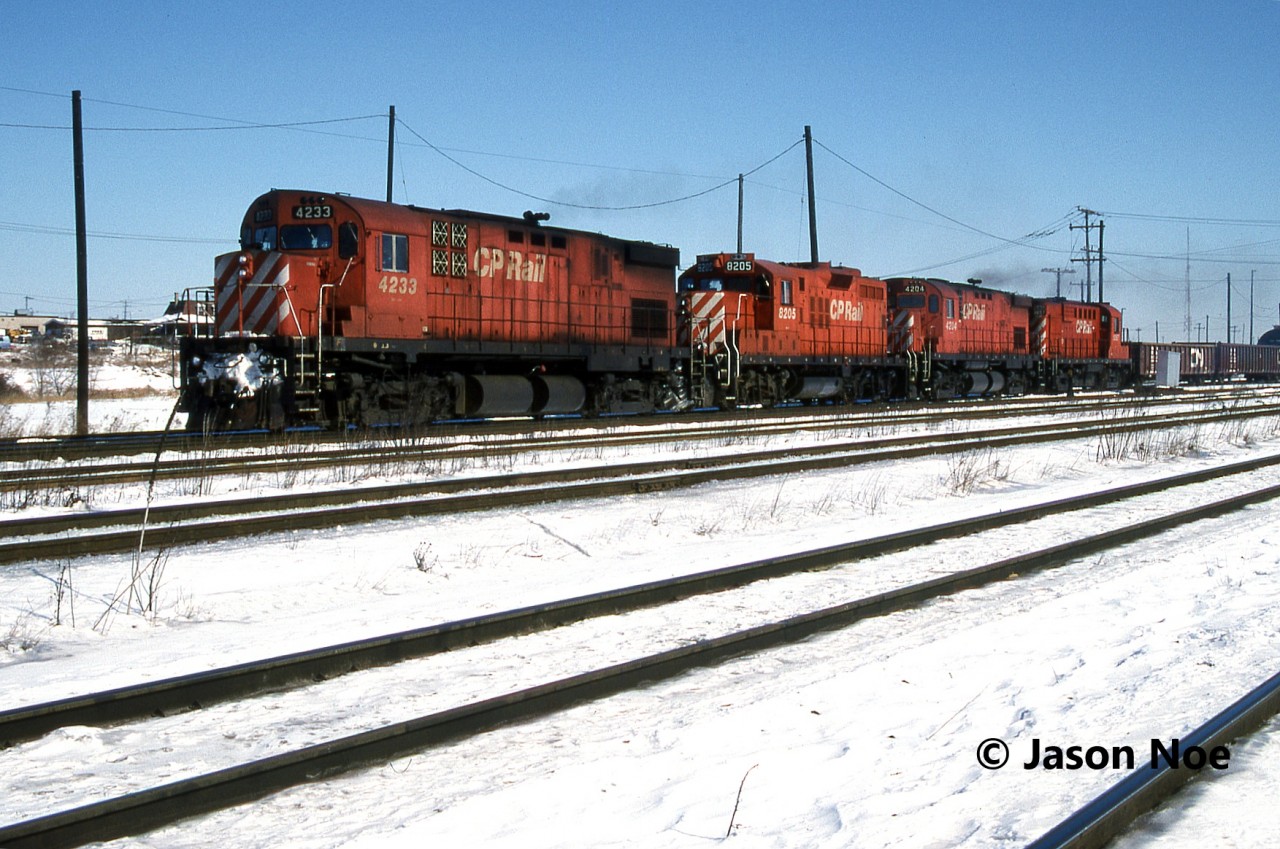 A westbound CP local departs Toronto Yard in Scarborough, Ontario with 4233, 8205, 4204 and 1857, possibly heading to Lambton Yard near West Toronto. The train also had CP caboose 434505 on the tail-end.