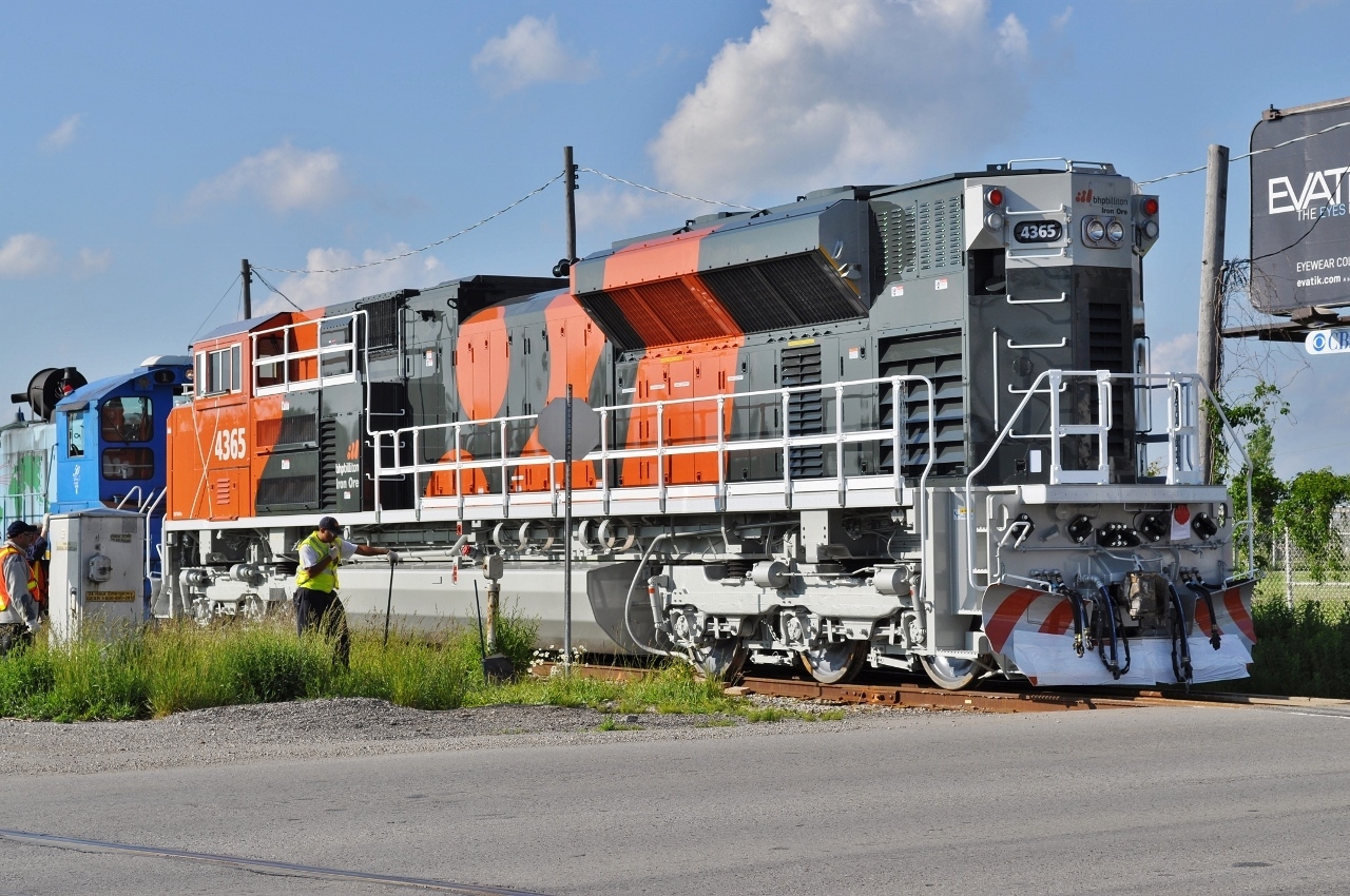 OH! OH!


After an uneventful  afternoon at Denfield...


... drive by EMD London ( 2005 – 2010) ….


...and a scene at the Oxford crossing !


Amongst the tall foreheads contained by their white hardhats, from the public sidewalk at the Oxford crossing, June 9, 2010 digital by S.Danko 


BHP 4365 did make it down under:


https://www.pilbararailways.com.au/gallery/displayimage.php?pid=15330


Noteworthy:


BHP Iron Ore run a motive power roster of 182 EMD and Progress Rail built SD70ACe locomotives with a large number of /LC and /LCi variants of which a full breakdown with names and serials can be found on the BHP Power Roster page. 


The sixth order #203 was for a total of eighteen SD70ACe locomotives numbered 4356 to 4373 with serial numbers: 20098203-001 to 018 and was the final order to be built by Electro-Motive in London Ontario Canada and delivered in two batches, it was also the final order delivered with ladder stirrups on each end of the locomotives, but the first delivery to have walkway kick plates.


The final nine (4365 - 4373) of this order were delivered to Nelson Point off the heavy lift ship Jumbo Challenger over the 2nd - 4th of September 2010. This brings the size of the SD70ACe and variants fleet to 73 locomotives. 


brief history per Wikipedia: 


April 4, 2005, GM sold its EMD subsidiary with its London and LaGrange operations to a partnership between Greenbriar Equity Group and Berkshire Partners. The company was renamed "Electro-Motive Diesel, Inc", thus retaining the EMD initials. EMD's Canadian subsidiary was renamed "Electro-Motive Canada". In 2010 EMD and its Canadian subsidiary were acquired by Caterpillar's subsidiary Progress Rail.[5][6] 


The plant was closed in 2012, after a labor dispute and leasing of a new plant in Muncie, Indiana.


sdfourty