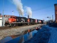 CN 7060 & CN 7017 let out a voluminous amount of smoke as CN 543 heads light power towards the Port of Montreal. The GP9s had just picked up CN 500's power (CN 4712 & IC 9639) which had died on East Side Canal Bank Spur much earlier that day.