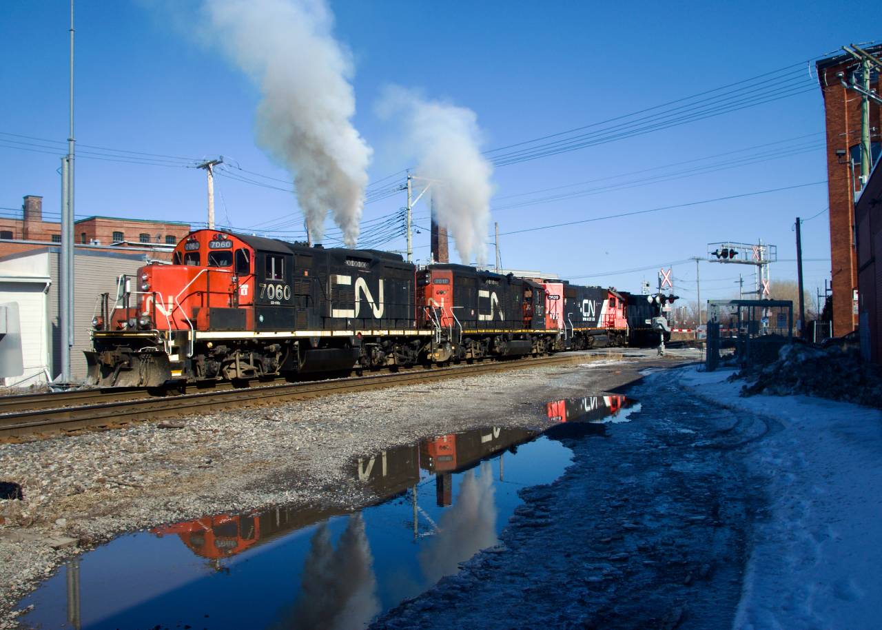 CN 7060 & CN 7017 let out a voluminous amount of smoke as CN 543 heads light power towards the Port of Montreal. The GP9s had just picked up CN 500's power (CN 4712 & IC 9639) which had died on East Side Canal Bank Spur much earlier that day.