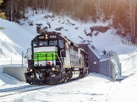Just over a month ago, in January 2026, the Société du Chemin de Fer de la Gaspésie resumed freight service on its railway between New Richmond and the Port-Daniel cement plant. Since 2013 when the railway shut down, the tracks were completely overhauled, many bridges and crossing signals were replaced, new retaining walls were built, the Port-Daniel tunnel was enlarged and the track even was relocated slightly at some places, to fight coastal erosion. Here we see the westbound trip as it just got out of the tunnel, which features some new concrete portals. For the time being, trains only run up to 15 miles per hour, stopping at a few unactivated railway crossings and making the round trip between New Richmond and Port-Daniel over the course of 2 days. 