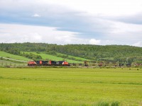 On June 17th 2023, while travelling on Route 132 between Rivière-du-Loup and Rimouski i passed train 402 around Trois-Pistoles. I decided to catch it along the highway just after Saint-Simon, which proved to be a good idea as train 559 led by CN 9523 and 9543 was about to enter the siding just as i arrived, allowing me to catch both trains at once. Unfortunately, 559 waited at the other end of the siding, so i did not take a good shot of both trains in the same picture.
