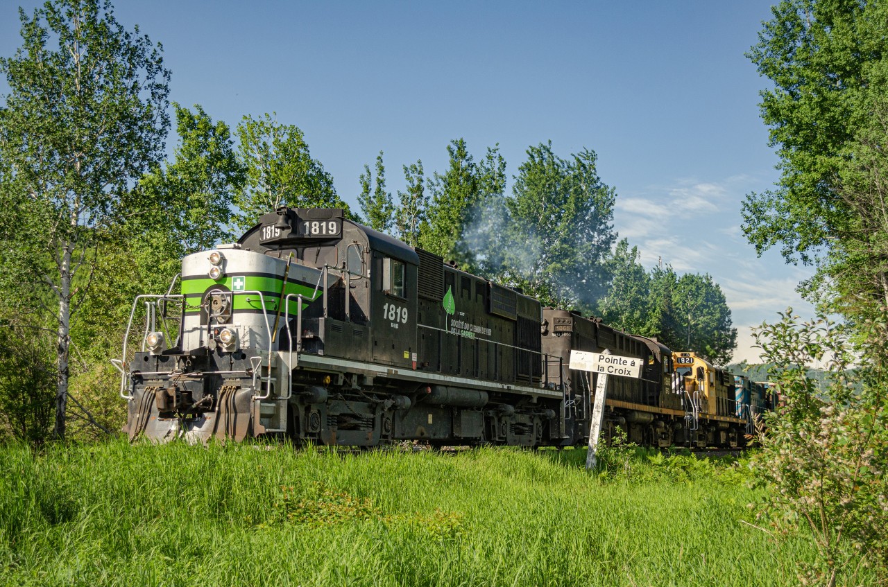 A quartet of SFG RS18us pulls a lenghty 565 past Pointe-à-la-Croix's station sign on a beautiful june afternoon. 1819 is one of only 2 RS18s painted in the company's regular paint scheme, and the only one still active.