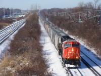 Grain train CPKC 322 unusually has CN power leading as it passes MP 11 of the Vaudreuil Sub in Beaconsfield, with fresh CN 8321 leading. CN's Kingston Sub is visible at left. With 145 grain loads, this train is just past the 20K tons mark.