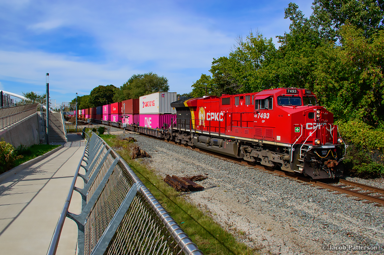 As numerous GO and Union Pearson train whoosh through the tunnel behind me, the crossing gates fall at the John Street pedestrian crossing for Montreal-bound CPKC 114 rumbling through Weston.