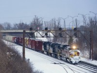 On a wet and dark morning, run-through train CN 529 has the Lackawanna heritage unit leading as it prepares to enter Taschereau Yard after a short delay. Fourty minutes later I would shoot CP 7018 leading CPKC 2114.