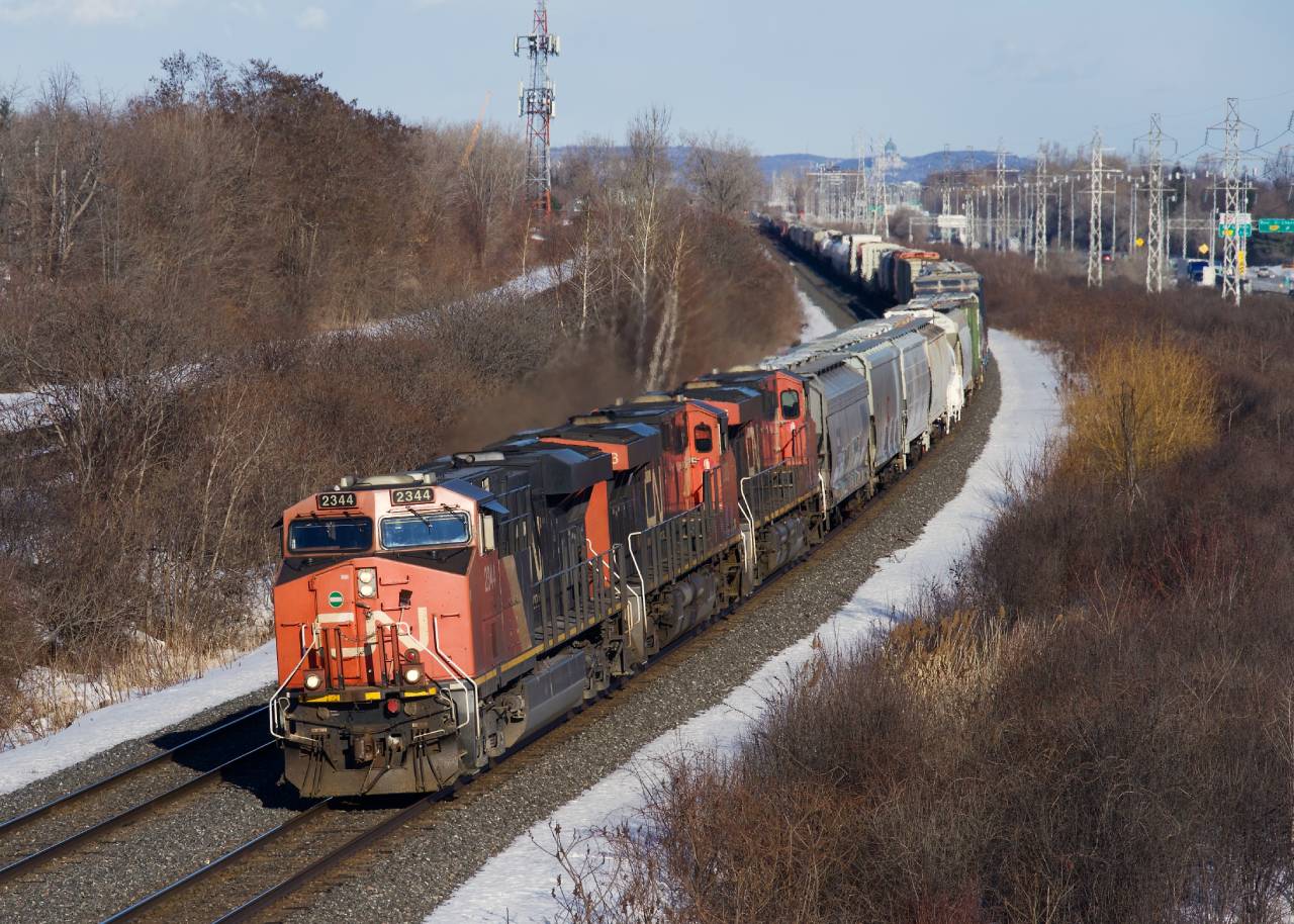 CN 369 has a trio of ES44DCs as it rounds a curve in Beaconsfield.