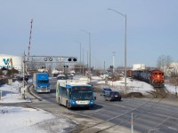 CN YRP002 has a pair of GP9s as it prepares to back loaded tank cars for Bitumar into a yard track before lifting empties from that client. The gates have just gone back up on busy Marien Avenue.