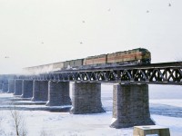 Operating as No. 221 on CP’s Adirondack sub, Delaware & Hudson’s Montreal Limited crosses the St. Lawrence River on its way to a scheduled 8:30 AM arrival at Windsor Station. Having departed Grand Central Station at 10:30 PM as part of Penn Central Train No. 63, the consist was turned over to the D&H at Albany-Rensselaer departing at 2:15 AM as its train No. 9. The same October 26, 1969 PC timetable describes accommodations as “Lounge Sleeping Car Bedrooms New York to Montreal (Beverages and Buffet Breakfast)",  "Sleeping Cars  Roomettes and Bedrooms New York to Montreal", and  "Reclining Seat Coaches Between all points”. Why the Erie Lackawanna E8s? Between mid-1968 and mid-1972 (after the EL bankruptcy), both D&H and EL were operated under common management in a holding company (DERECO) controlled by the Norfolk & Western. EL E-units were often used on the Montreal Limited and the Laurentian when PAs weren't available or additional steam heating capacity was deemed necessary.