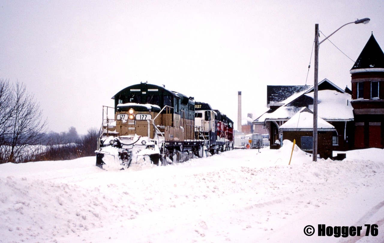Goderich-Exeter Railway train 581 is viewed passing the Goderich, Ontario station as it reverses down to lift several hoppers from the large Sifto salt mine. Powering the consist are GEXR GP38 3821, GSWR GP7u 2127 and GEXR GP9 177.