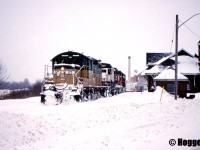 Goderich-Exeter Railway train 581 is viewed passing the Goderich, Ontario station as it reverses down to lift several hoppers from the large Sifto salt mine. Powering the consist are GEXR GP38 3821, GSWR GP7u 2127 and GEXR GP9 177.