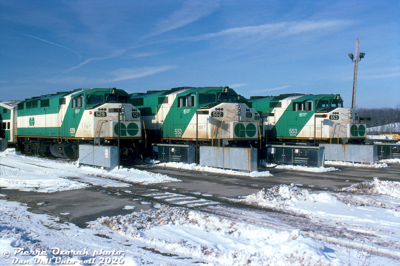 GO Transit F59PH's 529, 552 and 553 (with part of 535 tucked in, barely visible) sit at the layover yard at CP Guelph Junction. This was the original layover location for Milton line GO trains until a new Milton layover facility was built near Hornby off Fifth Line in the 2000's.

Pierre Ozorak photo, Dan Dell'Unto collection slide.

Note: longtime rail photographer and slide collector Pierre Ozorak recently passed away in January 2026.. Condolences to his friends and family, he will be missed by the rail photography community.